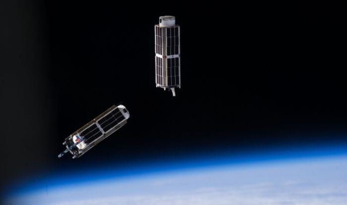 A set of NanoRacks CubeSats is photographed by an Expedition 38 crew member after the deployment by the NanoRacks Launcher attached to the end of the Japanese robotic arm. Credits: NASA
